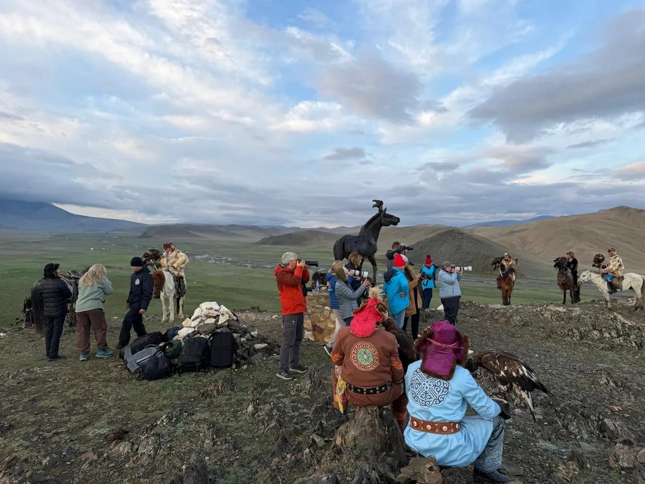 Visitors photographing Kazakh eagle hunters in the Altai Mountains of western Mongolia