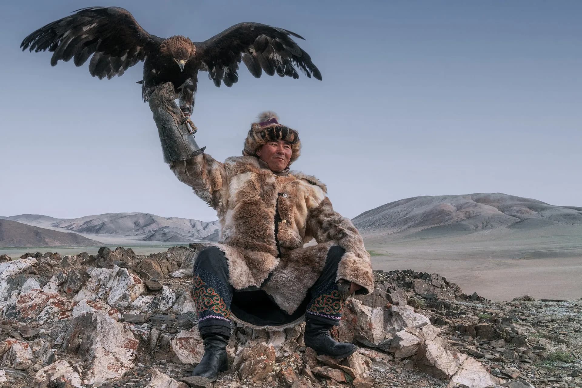 Kazakh eagle hunter with a golden eagle in the Altai region