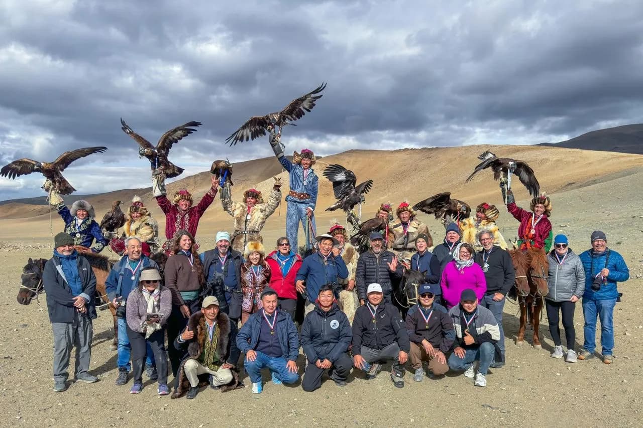 International guests with Kazakh eagle hunters at a private festival